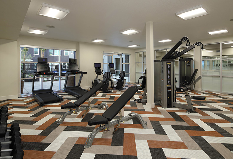 A fitness center with exercise equipment.