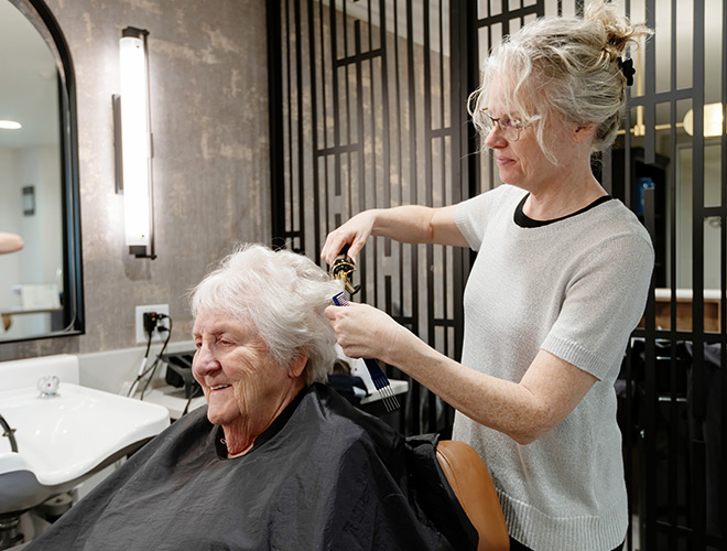A person getting their hair styled.