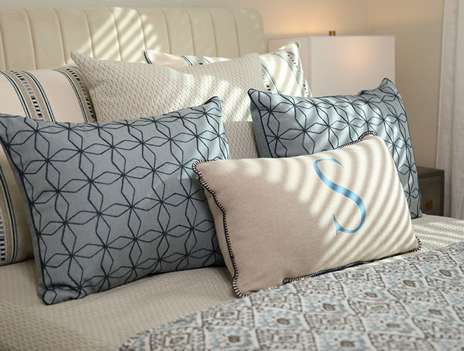 A bunch of pillows on a bed.