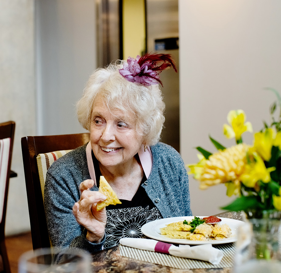 A resident eating gourmet bites.