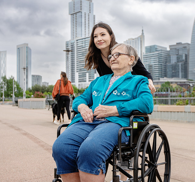 A resident out in the city with a naya caregiver.