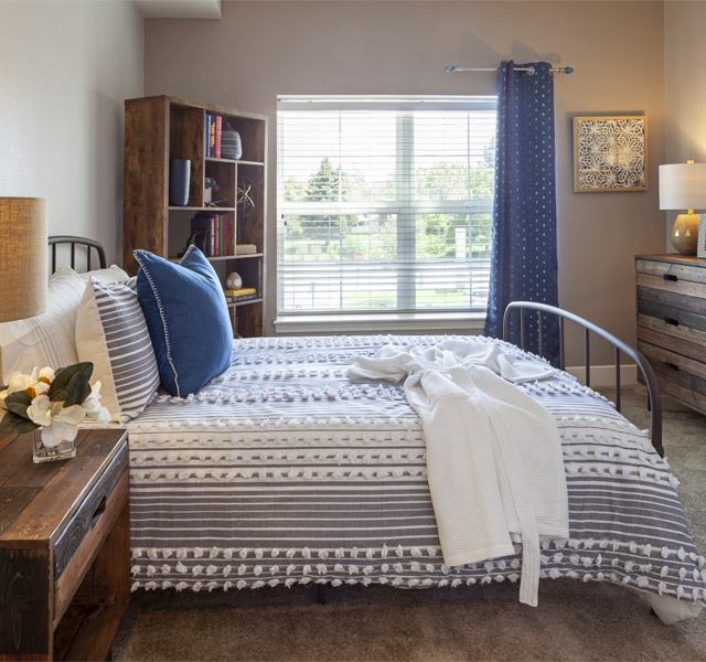 Bright bedroom with twin bed and large window.