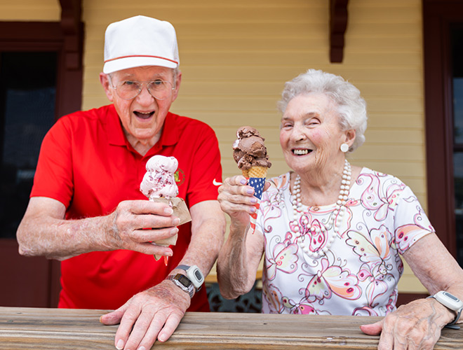 Two residents eating ice cream outside.