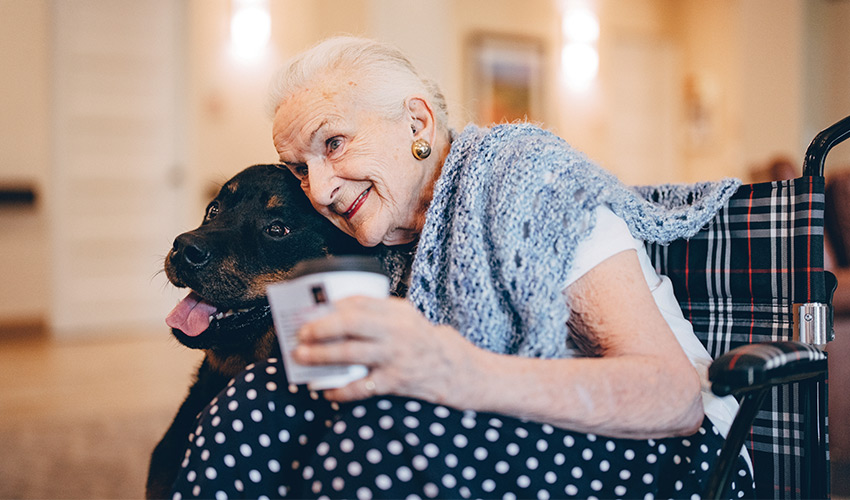 A resident hugging a dog.