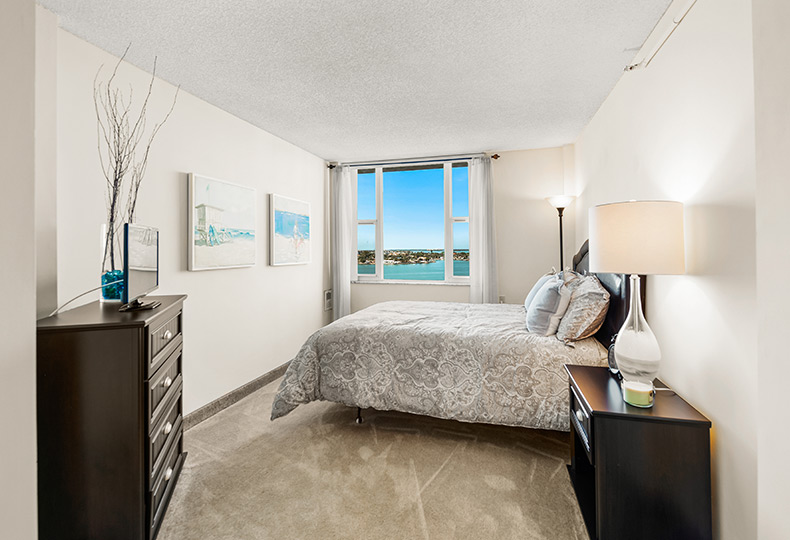 Fully furnished bedroom with an ocean view.