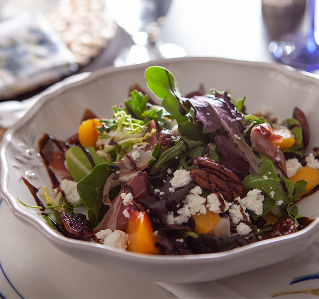A colorful salad with nuts and cheese.