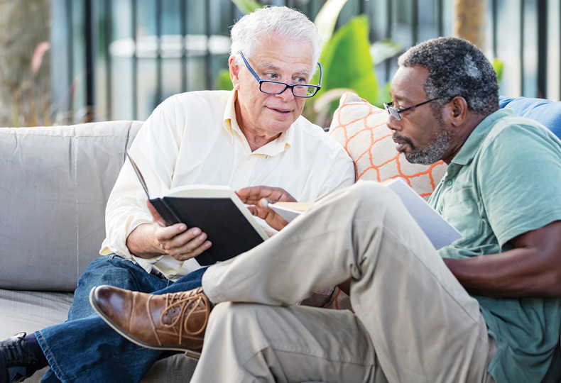 Two residents are reading a book.