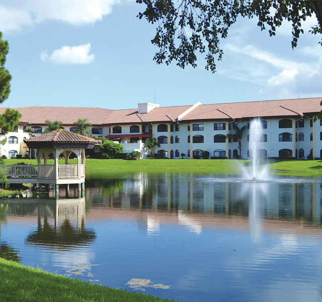 scenic view of lake, fountain and community buildings