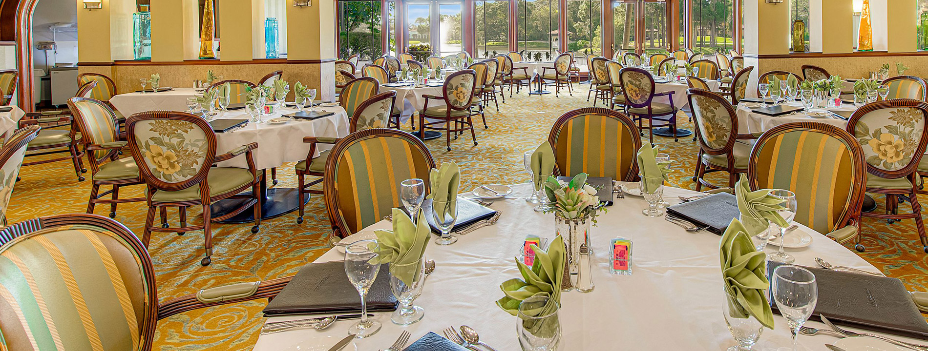 dining area with set tables and white tablecloths