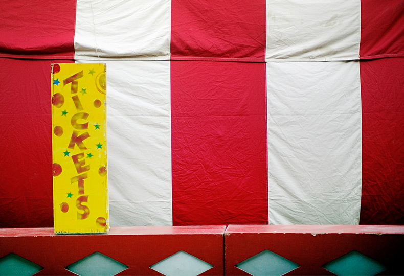 Circus tent with a large yellow tickets sign.