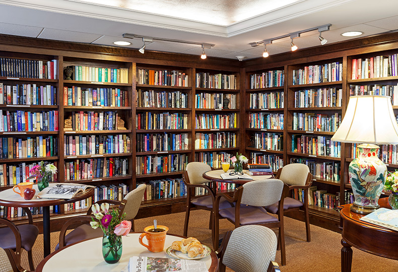 Library room filled with books and seating area.