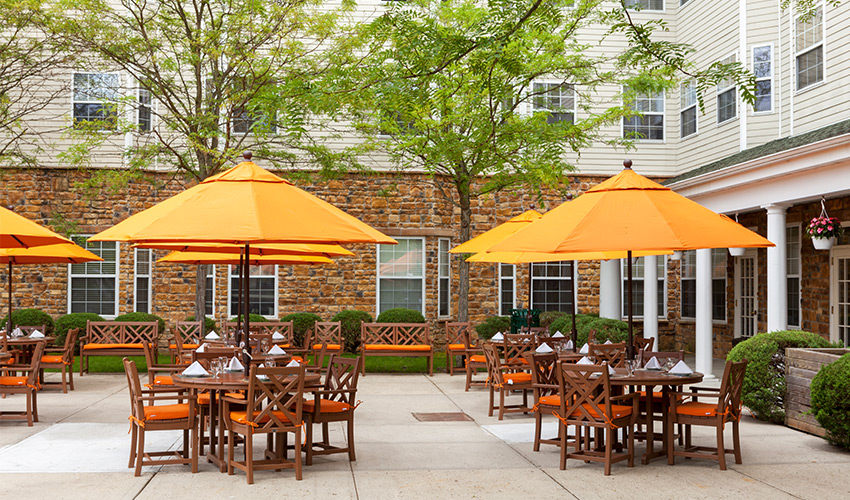 outside patio with tables set and umbrellas