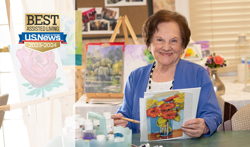 A person with a painting they created.