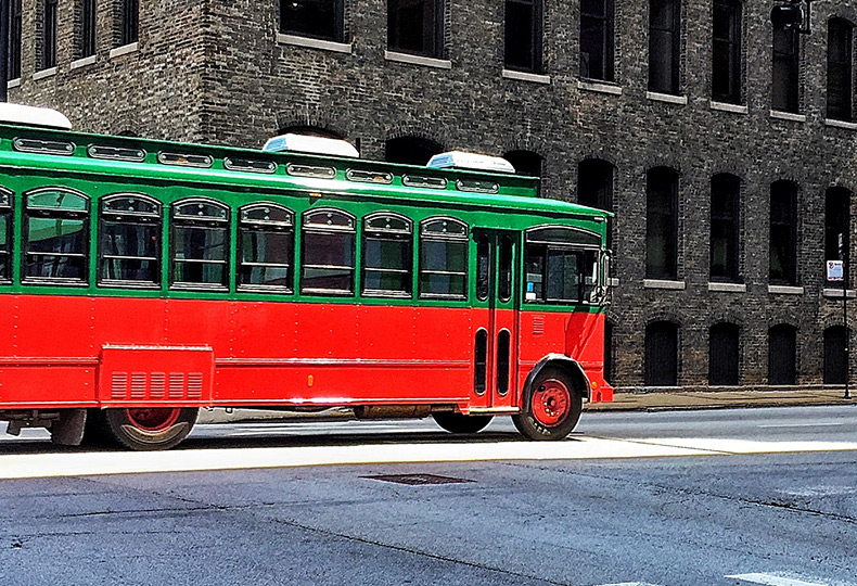Trolly going down a street.