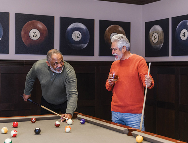 Two residents are playing pool.