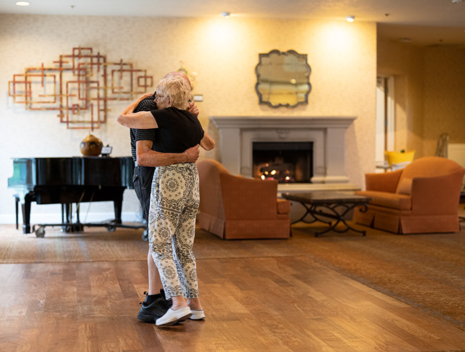 Two residents are dancing.