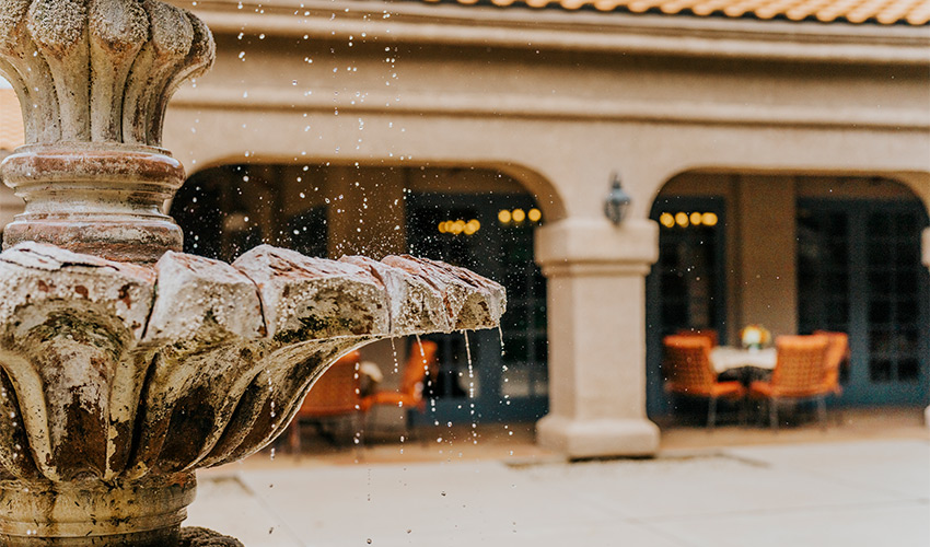 A fountain with water running off of it.