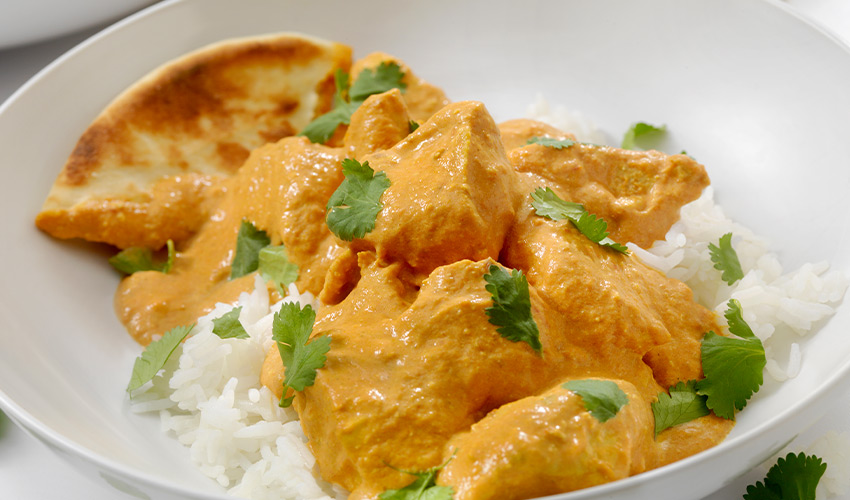 A bowl of chicken curry and rice.