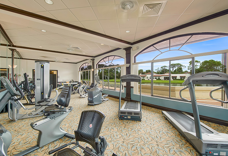 An assortment of fitness equipment including a bike, trampoline and stairs with railing found on-site at The Fountains at The Albemarle.