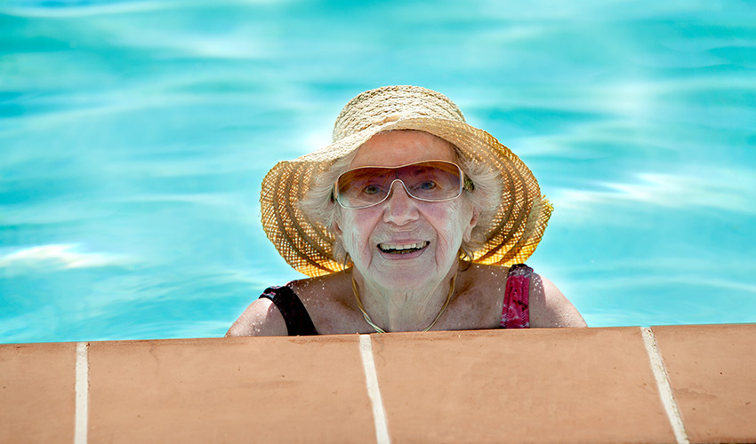 A women in a hat in the pool.
