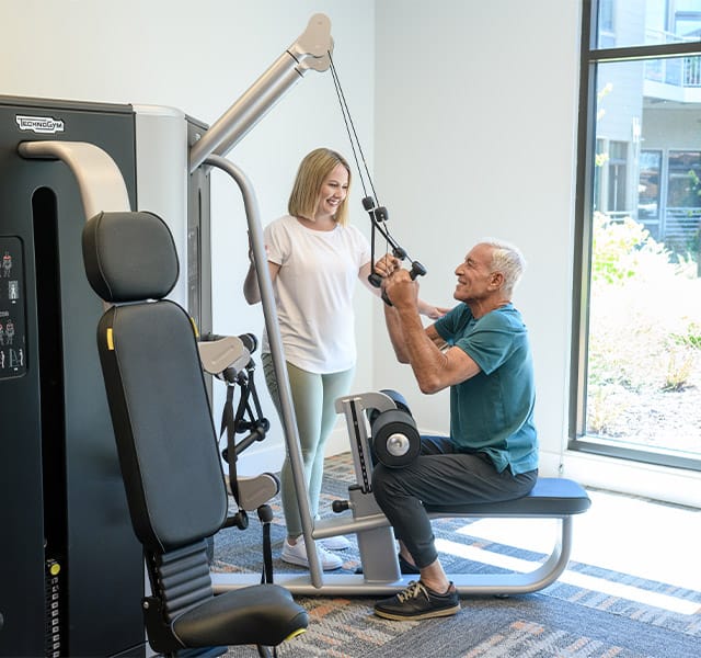 Residents enjoying the gym and fitness machines.