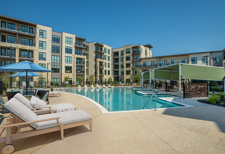An outdoor pool with cabanas.