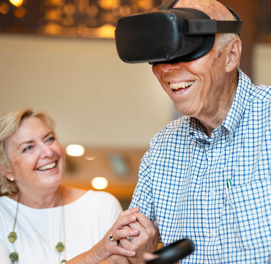 Residents enjoying virtual reality wearing goggles and holding controls.