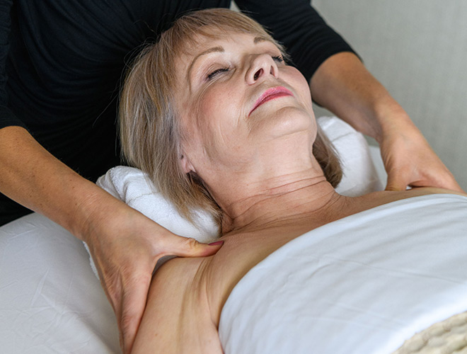 A resident gets massage by masseuse.
