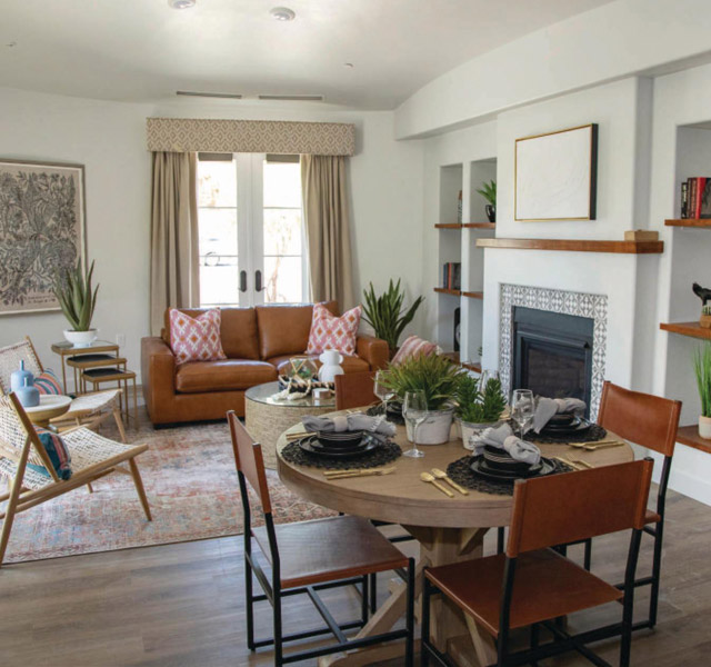 Furnished living room space with sofa, table, and seating area.