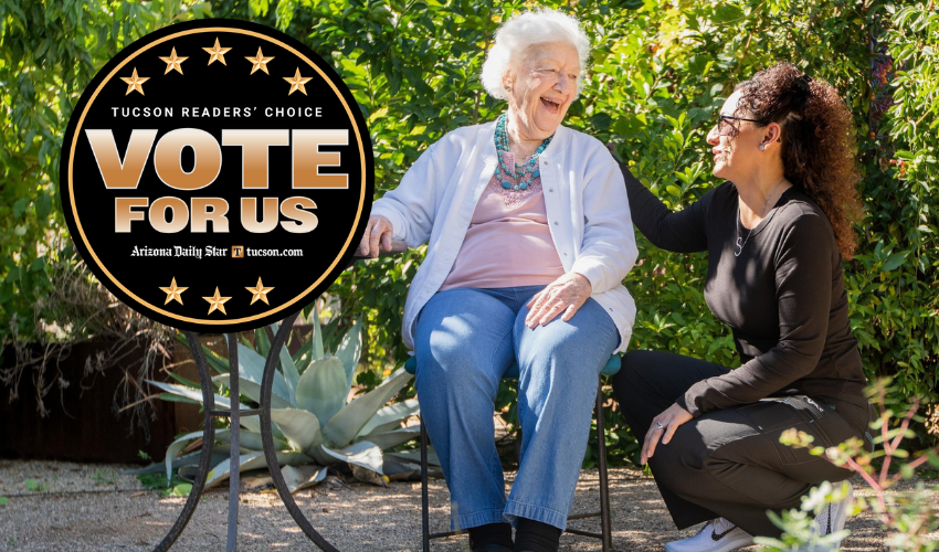 A caregiver and a resident are laughing.