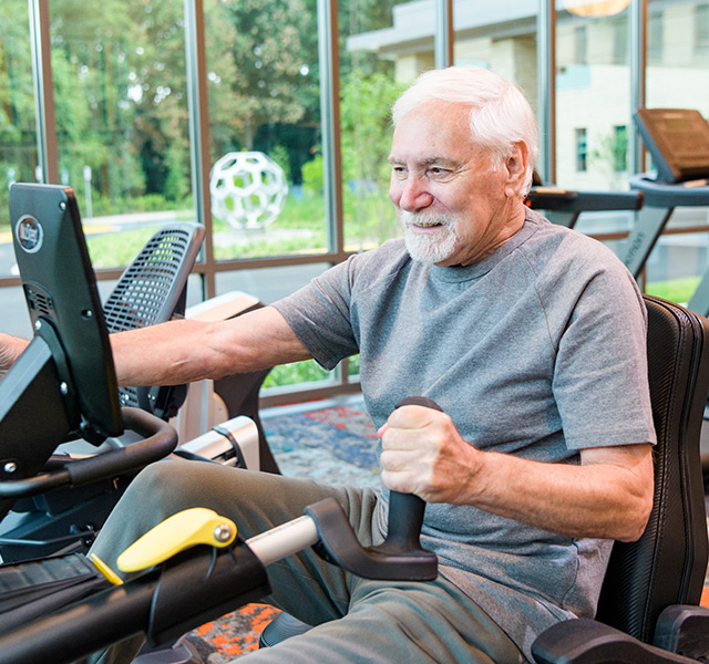 close up of resident using a fitness machine