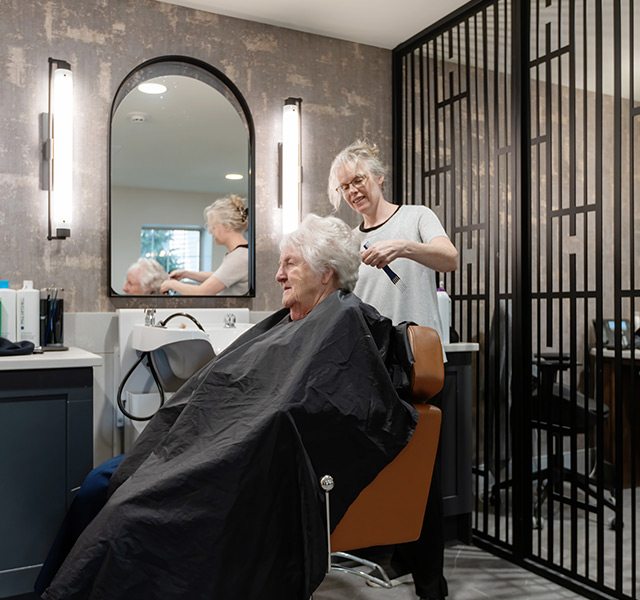 A person getting their hair styled at the salon.