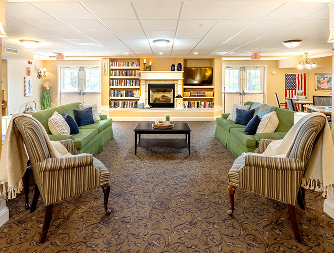 A common living room area with seating and a fireplace.