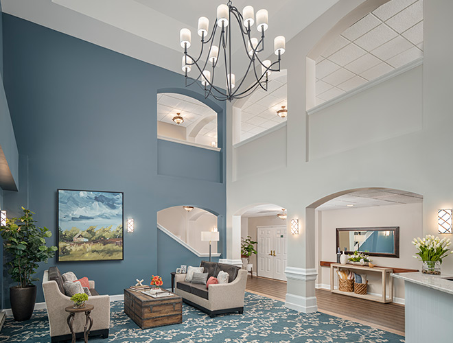 A beautiful lobby with tall ceilings and a chandelier.