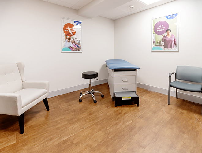 A clinic room with an exam table.