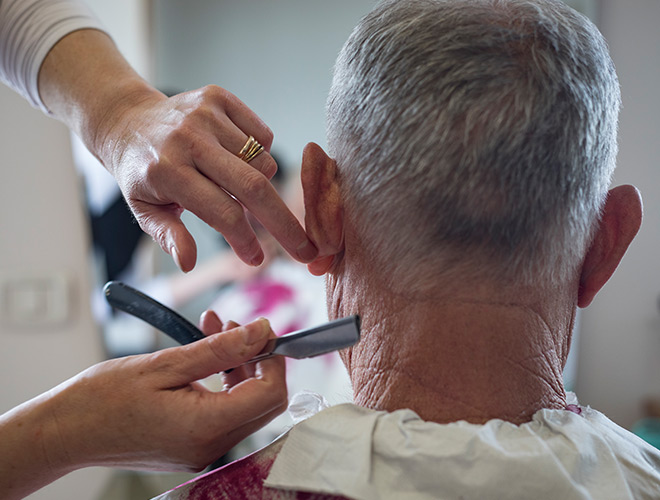 A resident is having their haircut.
