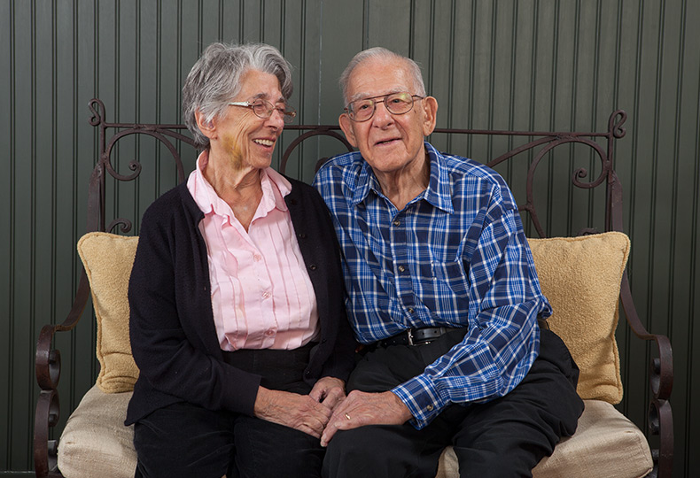 Two residents are sitting on a sofa.