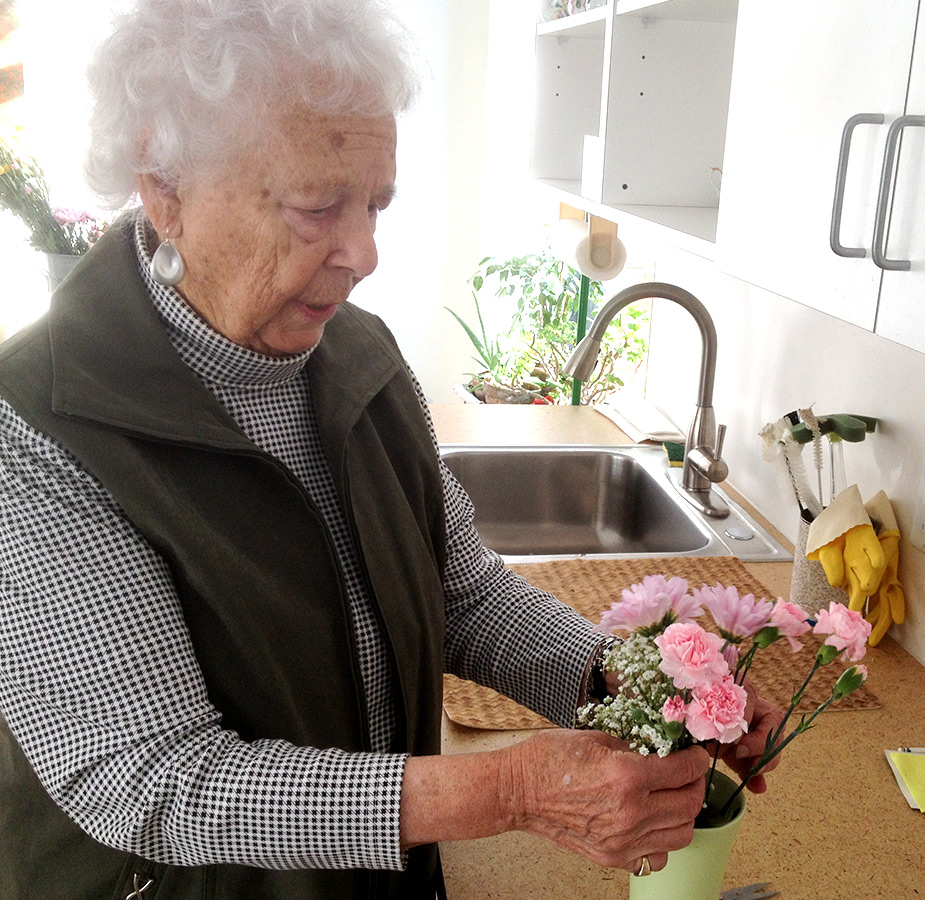 A resident is arranging flowers.