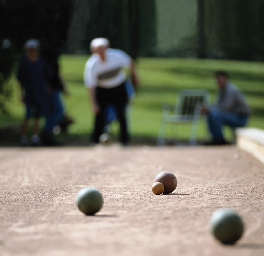 A resident is playing bocce ball.