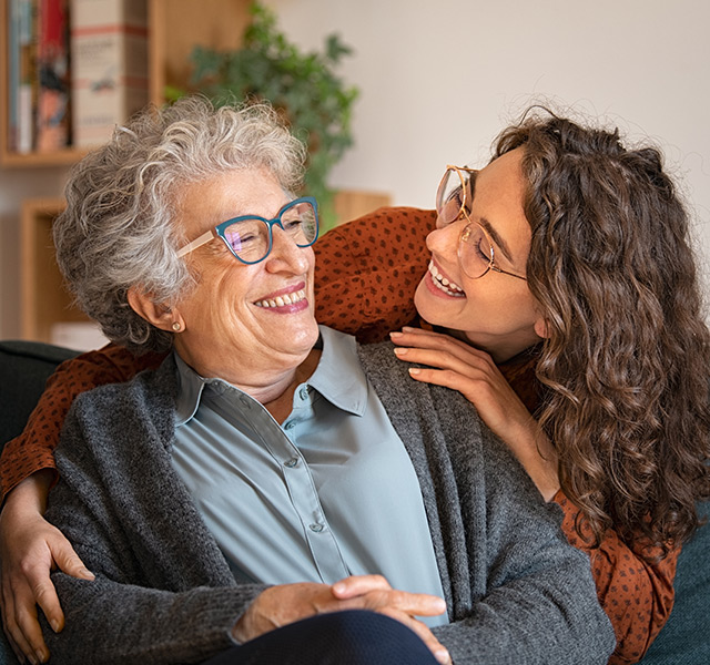 A resident is smiling at their caregiver.