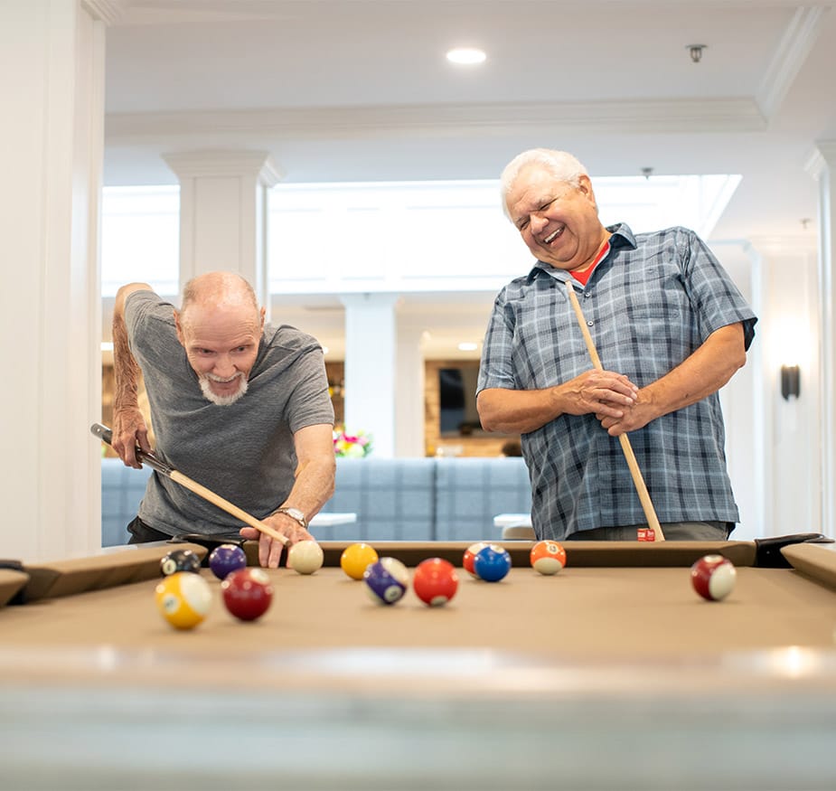Residents are playing a game of pool.