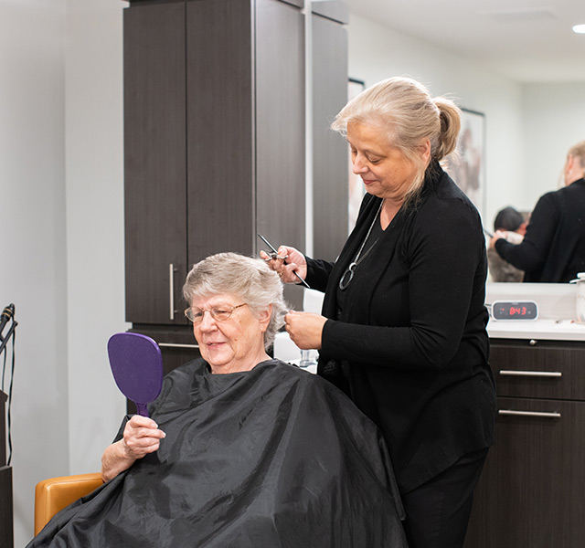 A resident is getting their hair done at the salon.