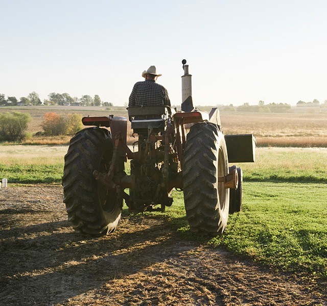 A farmer on a tractor.