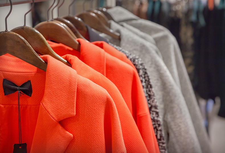 Colorful coats on hangers.