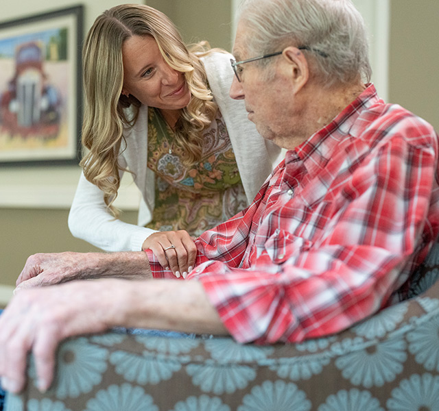 A resident is talking with their caregiver.