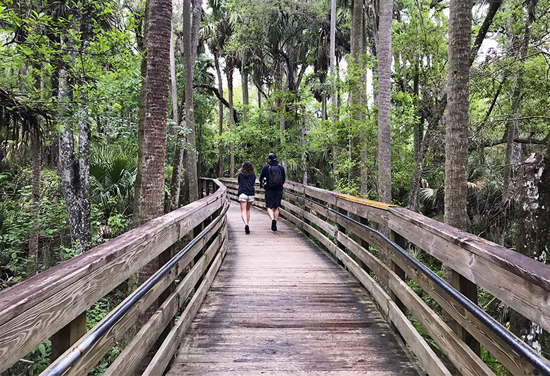 Two people walking on a trail.
