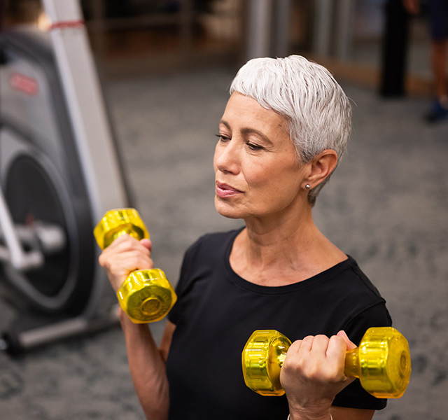 A person lifting weights at the gym.