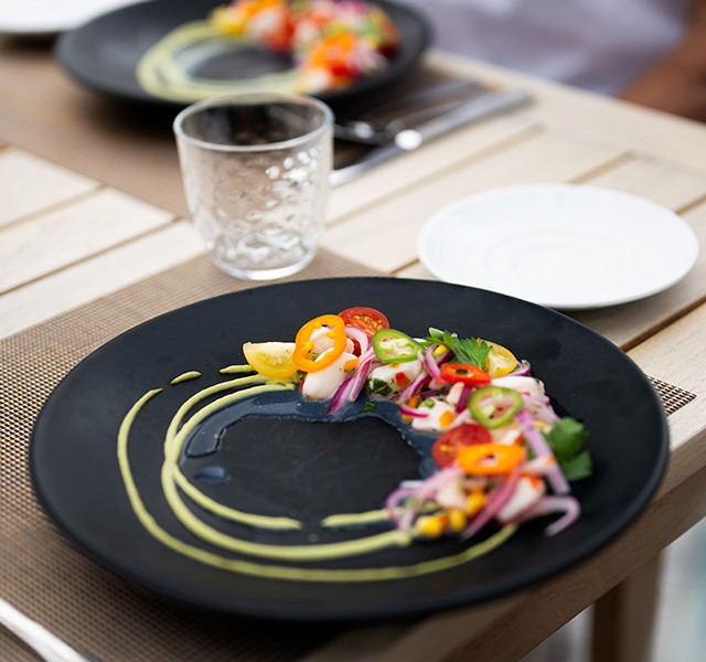 A plate on the table with a fresh salad on it.