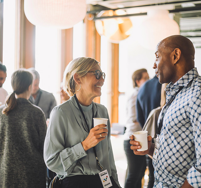 A group of professionals networking over drinks.