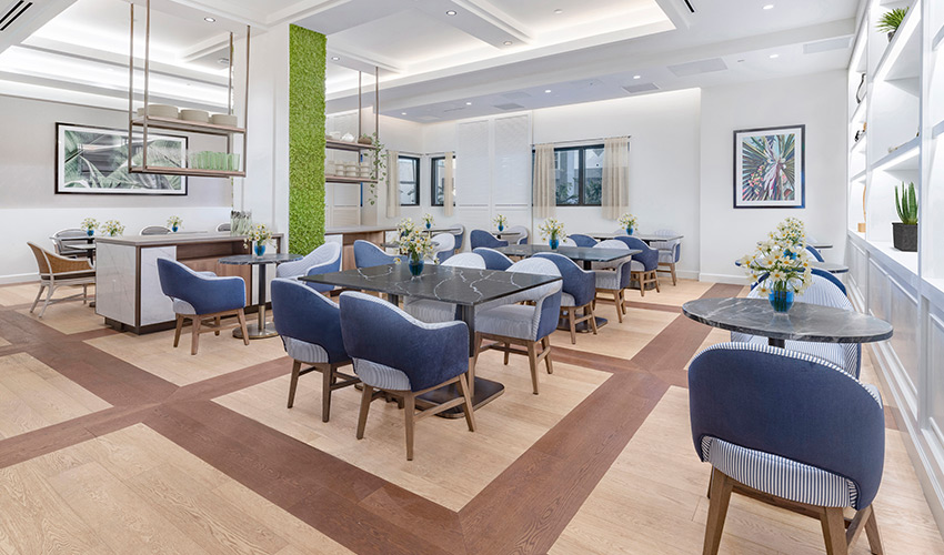 modern dining room with multiple tables with navy chairs
